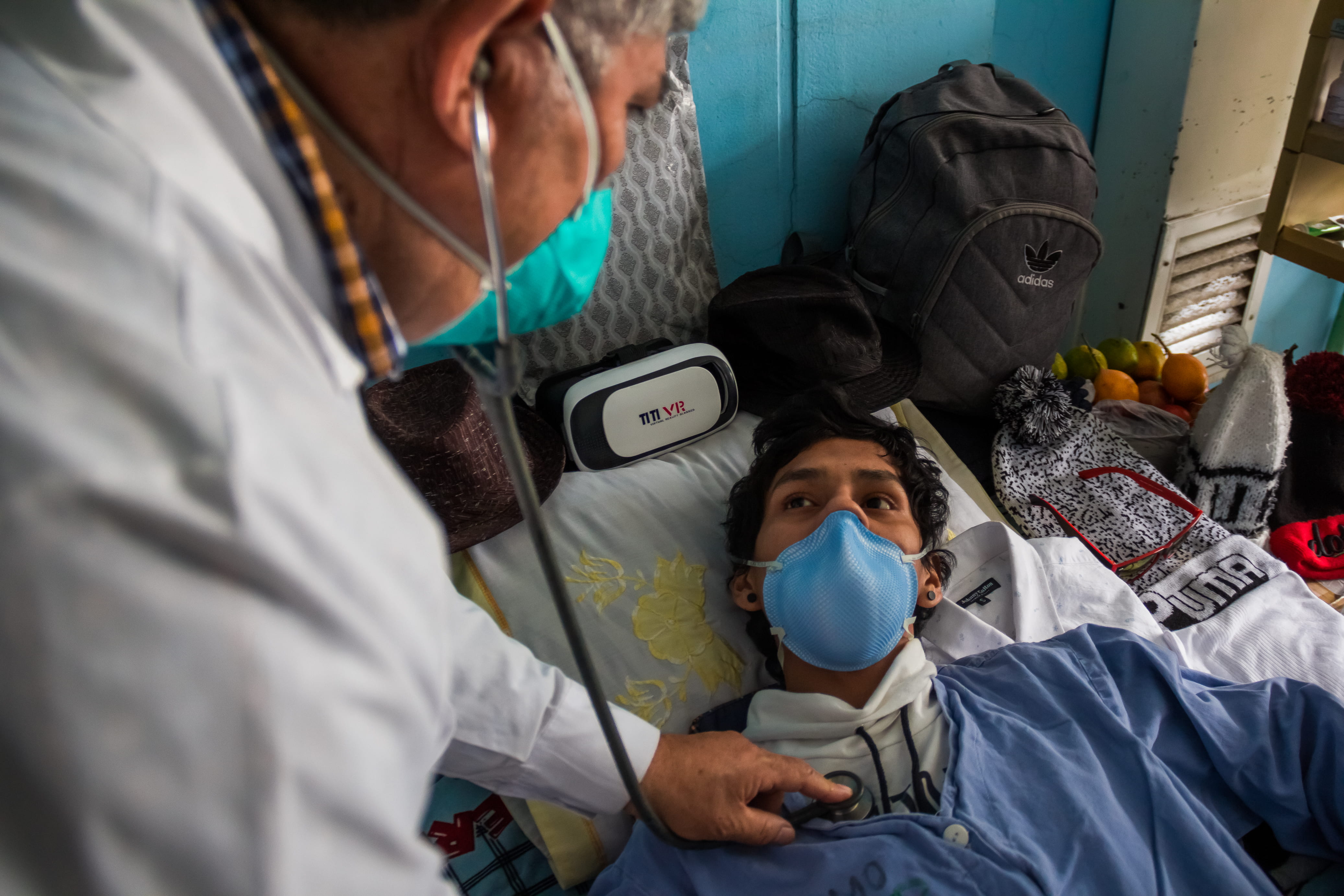 Doctor caring for patient at bedside in Peru hospital
