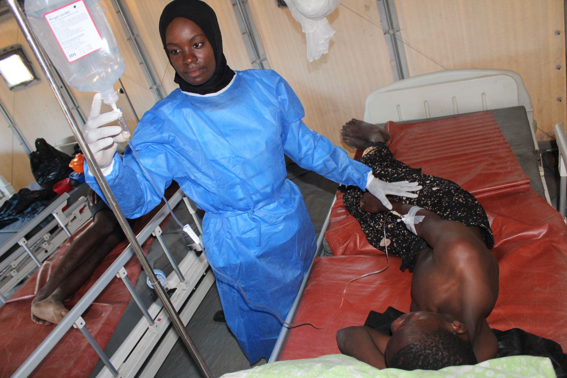 health worker tending to cholera patient 