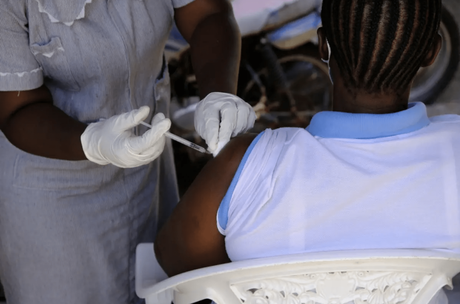 person receiving covid vaccine in upper arm