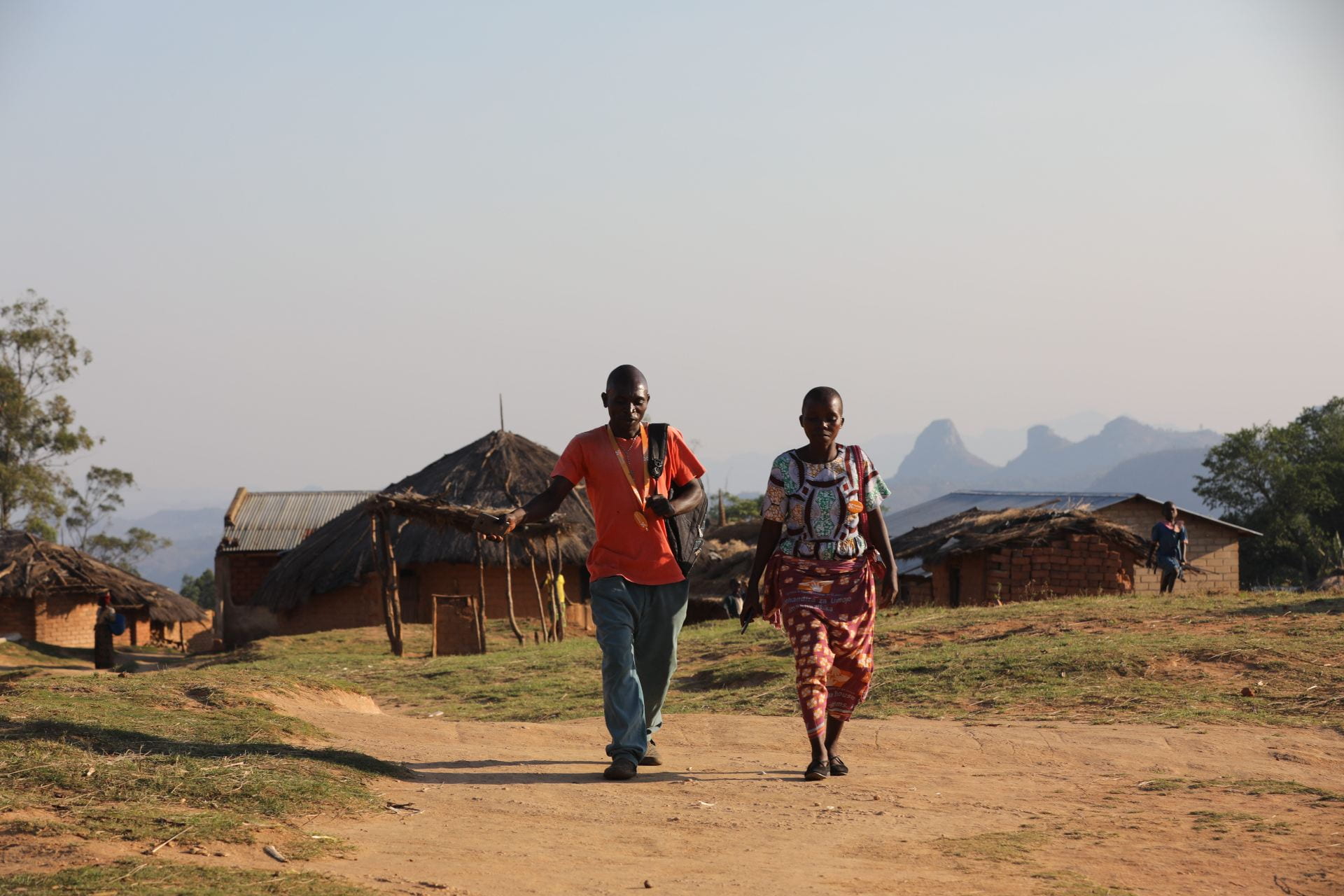community health worker and resident walking